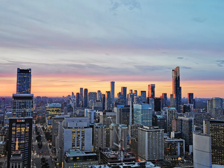 A vibrant aerial view of best Toronto neighborhoods showcasing modern architecture, green spaces, and bustling city life, highlighting the diverse charm and investment potential of the area.