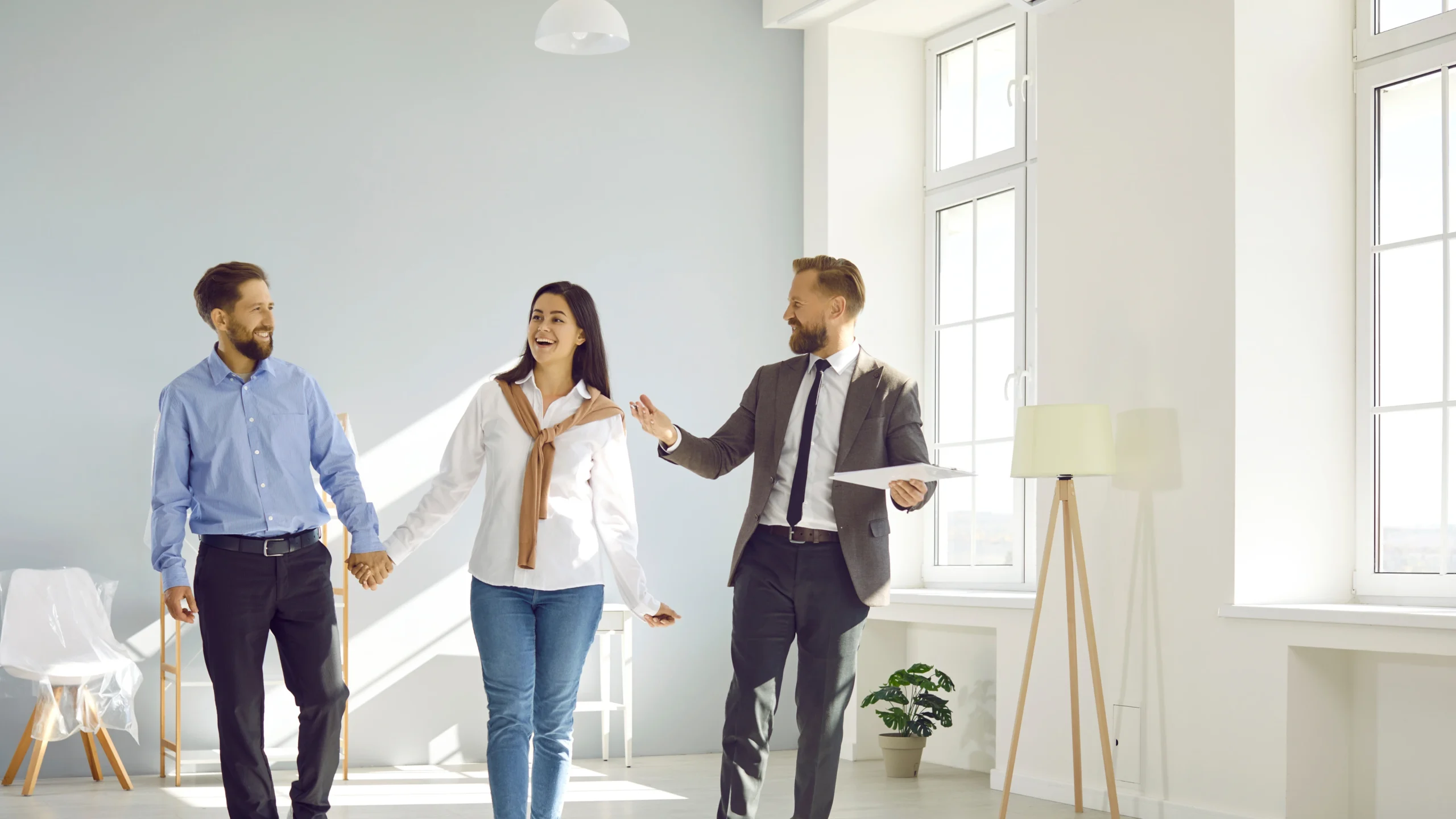 A professional realtor standing in front of a house, showcasing local expertise in buying, selling, and investing like a Realtor near me